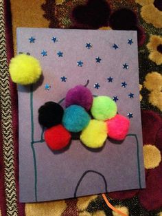 a piece of paper with pom poms on it