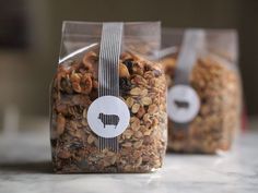 two bags of granola sitting on top of a counter