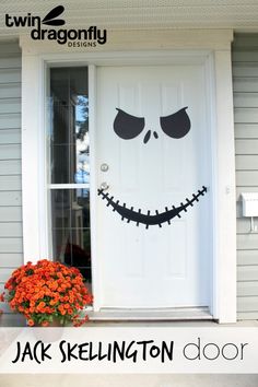 the front door decorated for halloween with jack skellington's face and pumpkins