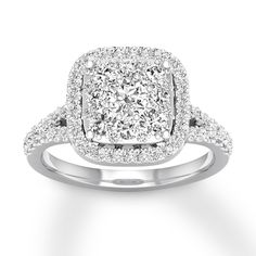 a cushion shaped diamond ring with pave set shoulders