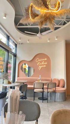 the inside of a restaurant with chairs, tables and chandeliers hanging from the ceiling