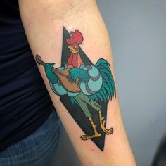 a rooster with a guitar tattoo on the arm