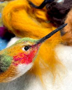 two needled wool birds with different colors on them