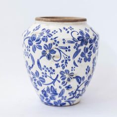 a blue and white vase sitting on top of a table