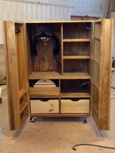 an open wooden cabinet with drawers and shelves