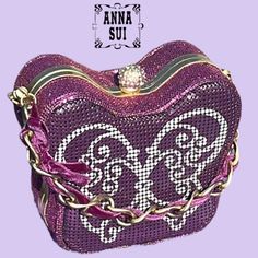 a purple purse with an ornate design on it