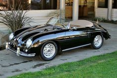 a black sports car parked in front of a building