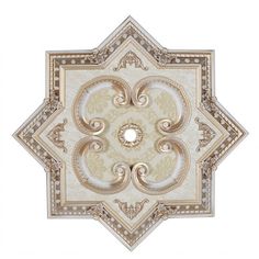 an intricately designed wall decoration with gold and white designs on the top, along with other decorative elements