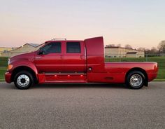 a red pick up truck parked in a parking lot