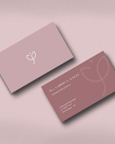 two business cards on top of each other, one with a flower in the middle