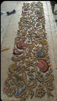 an embroidered table runner is being worked on