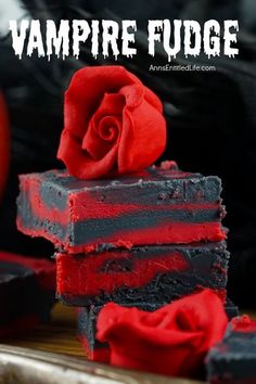 two pieces of vampire fudge cake with red frosting and a rose on top