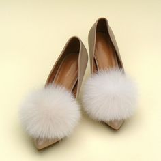 "Add a touch of whimsical charm to your wedding ensemble with these exquisite Fluffy Wedding Pom Pom Shoe Clips! Handcrafted with love, these clips feature lusciously soft and ethically sourced fox fur, ensuring both elegance and sustainability. Each pom pom is meticulously made to perfection, creating a delightful burst of fluffy luxury that will effortlessly enhance your bridal shoes. These versatile clips can be easily attached to any pair of shoes, allowing you to customize your look and embrace your unique style on your special day. Whether you're walking down the aisle or dancing the night away, these pom pom shoe clips are the perfect accessory for every bride seeking a dash of enchantment and a touch of glamour. Embrace the joy of your wedding day with these delightful and eco-cons Fluffy Shoes, Shoe Decorations, Fox Fur Jacket, White Wedding Shoes, Fur Accessories, Cream Shoes, Bride Accessories, Bow Shoes, Womens Wedding Shoes