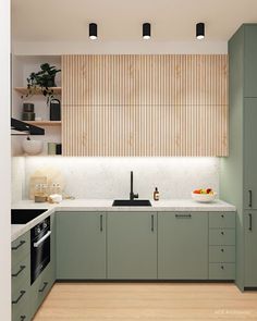 a modern kitchen with green cabinets and white counter tops, wood paneling on the wall