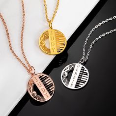 three necklaces with different designs on them