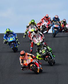 a group of motorcyclists racing on a race track