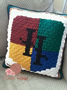 a crocheted pillow sitting on top of a couch