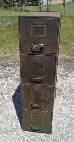 an old metal file cabinet sitting on the ground