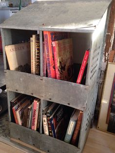 a wooden crate filled with books on top of a table