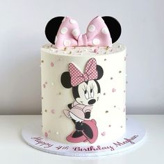 a minnie mouse cake with pink bows on top