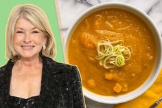 a woman standing in front of a bowl of soup with noodles on it and an orange napkin