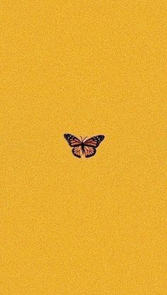 a butterfly flying in the sky with yellow background