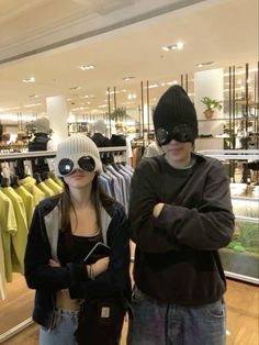 two people standing next to each other in a store