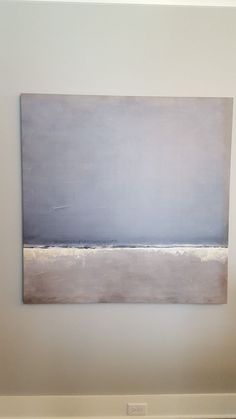 an abstract painting hangs on the wall