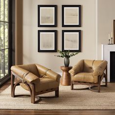 a living room with two chairs and a table in front of a fire place next to a fireplace