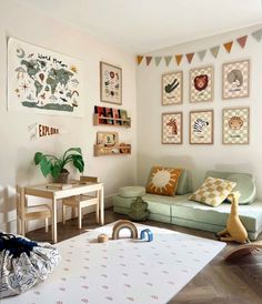 a living room filled with furniture and pictures on the wall