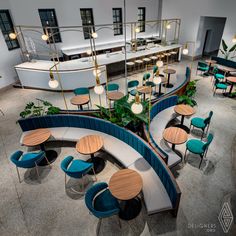 an overhead view of a restaurant with blue chairs and round tables in front of the counter