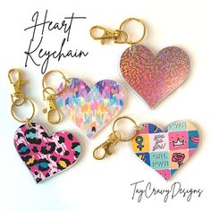 four heart shaped keychains with different designs on them and the words happy valentine's day written below