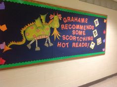 there is a sign on the wall that says grahame recommends some scorching hot reads