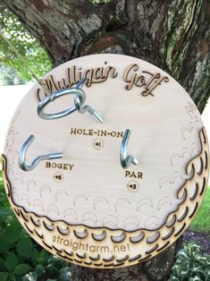 a tree with a sign on it that says mulligar golf and holn - in - non boezy par