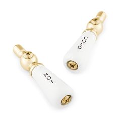 two white and gold ear plugs with the word joy written on each one side