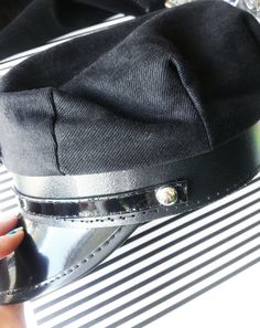 a close up of a person's hand with a hat on top of it