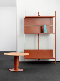 an orange shelf next to a round table