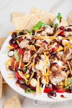 a white plate topped with salad and tortilla chips