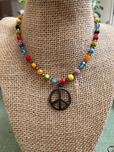 "The Happy Hippie Necklace is handbeaded with colorful Millefiori Italian Glass beads and Czech Glass beads.  Vintage Spirit Design Jewelry incorporates vintage elements into all of our jewelry. This is our way of recycling and reusing many beautiful pieces of jewelry that served their purpose in one form.  The Peace Sign Pendant on this necklace is 1\" in diameter.  The necklace comes in Silver or Antique Bronze. The hardware matches the metal of the Peace sign - so please choose which one you Cheap Adjustable Jewelry With Peace Sign, Cheap Colorful Hippie Beads, Vintage Multicolor Heart Beads Necklace, Colorful Hippie Round Bead Jewelry, Colorful Czech Glass Beaded Necklaces For Gifts, Hippie Style Colorful Round Bead Jewelry, Multicolor Beaded Necklaces For Birthday, Colorful Round Beads Necklace For Birthday, Beaded Necklaces With Colorful Beads For Birthday