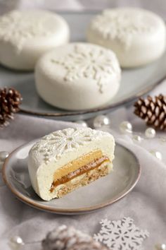 a piece of cake sitting on top of a plate next to pine cones and snowflakes