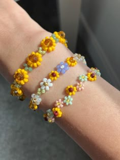 Inspired by their bright beauty, each bracelet is carefully made to add a touch of sunshine to your jewelry collection.  Bracelet Info  Size:      - option A -- 1cm (Width)      - option B --  0.8cm (Width)     - option C --  1cm (Width)  All three bracelet lengths are 15cm with 5cm chain extender Overall size: 20cm (including chain extender) Finding Material: Gold-plated brass Beads: Seed beads, glass rondelle beads The fish line may be visible. Since each sunflower length is fixed, custom brac Tiny Beaded Bracelets Flower, Trendy Jewelry With Flower Decoration For Gift, Trendy Flower Decorated Jewelry As Gift, Trendy Flower Decorated Jewelry Gift, Trendy Floral Jewelry For Gifts, Handmade Gold Bracelets For Spring, Cute Handmade Gold Beaded Bracelets, Yellow Bohemian Flower Bracelets, Adjustable Delicate Beaded Bracelets With Flower Charm