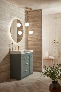 a bathroom with a sink, mirror and potted plant on the floor in front of it