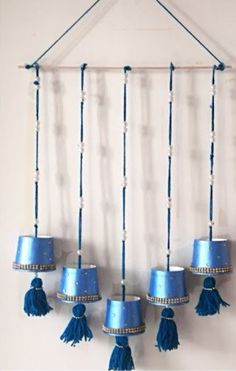 blue lamps hanging from the ceiling with tassels