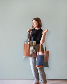 a woman holding two bags in her hands