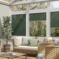 a living room filled with furniture and windows covered in blinds