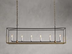 a rectangular chandelier with five candles hanging from the bottom and four lights on each end