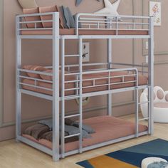 a metal bunk bed sitting on top of a hard wood floor next to a wall