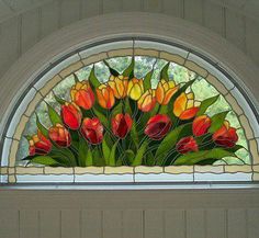 a stained glass window with red and yellow tulips