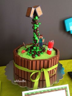 a cake that is sitting on top of a wooden table with a green ribbon around it