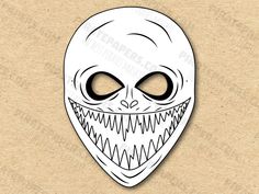 an alien mask with large eyes and fangs on it's face, in white paper